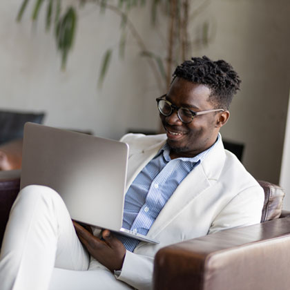 Man smiling working on his laptop