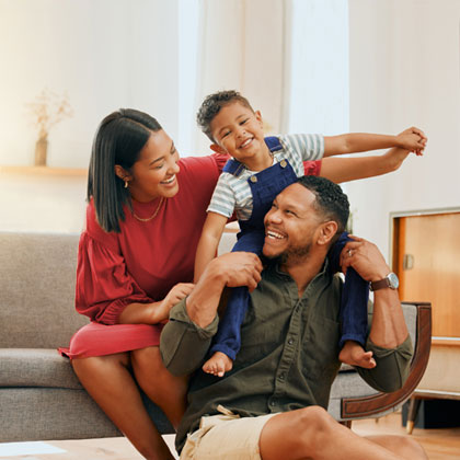 Couple hugging with house in background